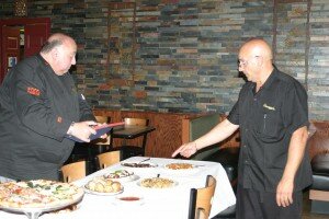 Chef Tom Macrina, left, inspects Giuseppe’s entrees on behalf of the US Foods Family Friendly Restaurant Contest.