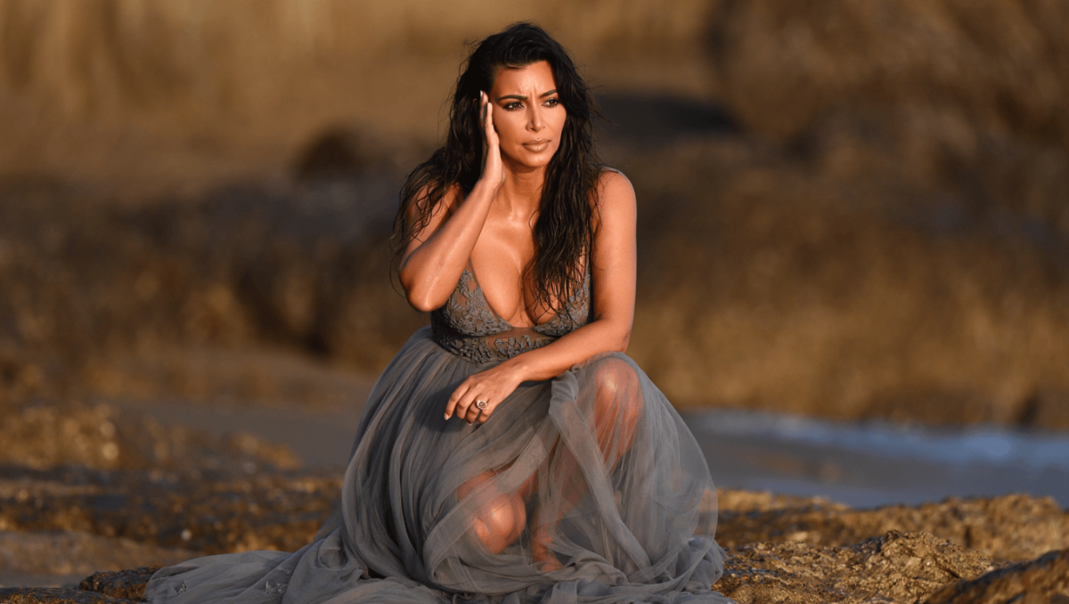 
		Kim Kardashian dazzles in sheer lace dress on the beach before revealing she failed bar exam	