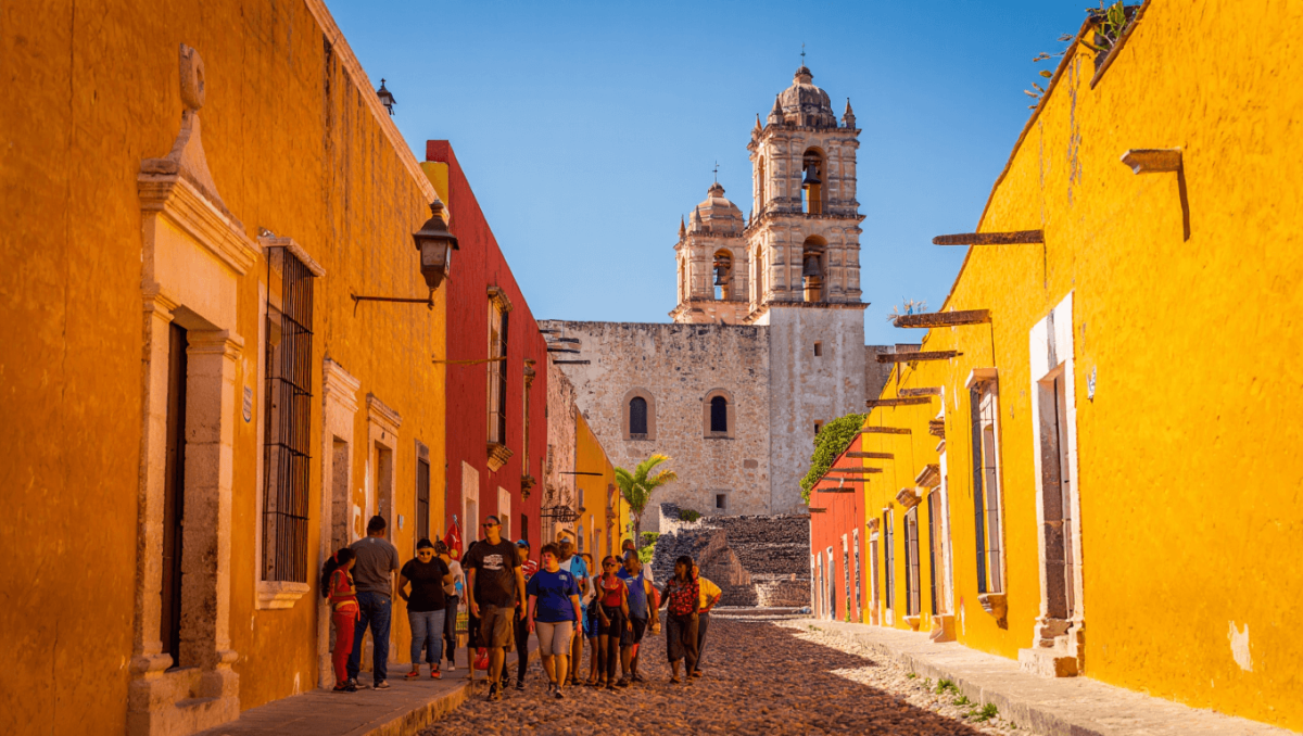 Young Woman Admiring The Colonial Architecture Of Izamal, Mexico