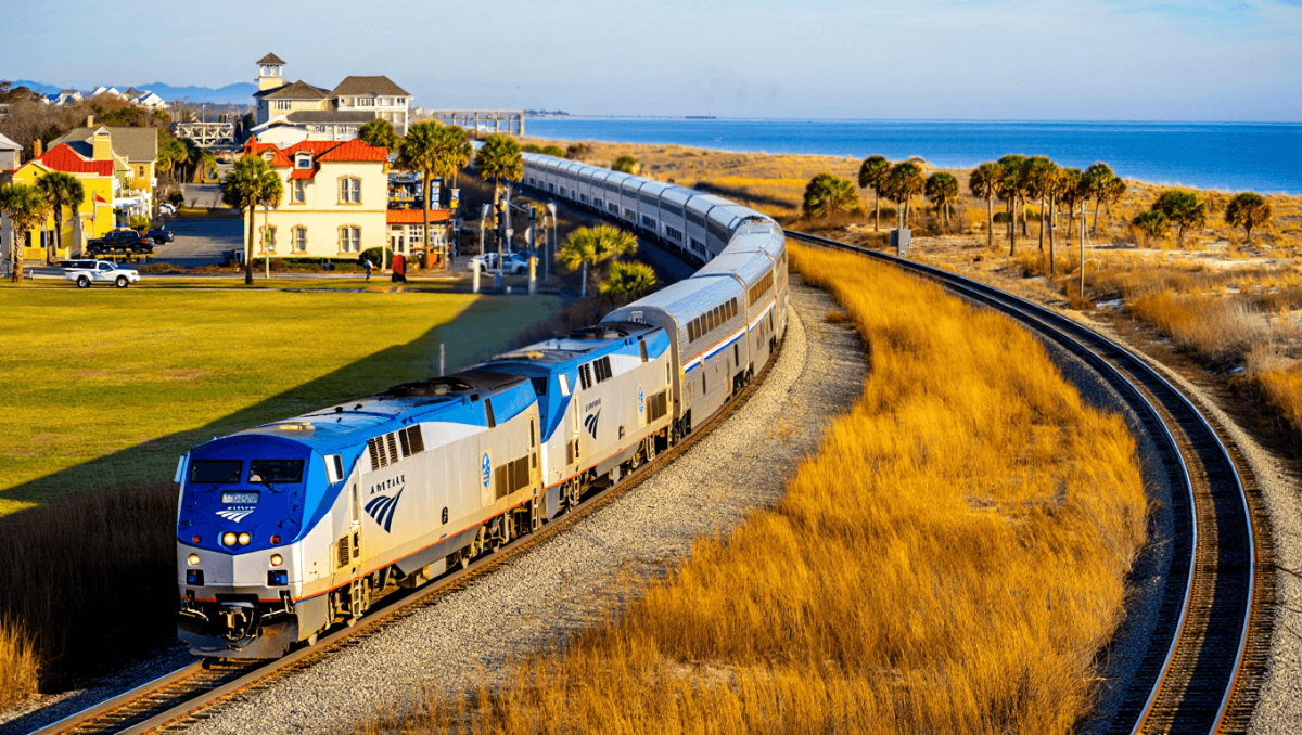 Woman with pink luggage waiting for train