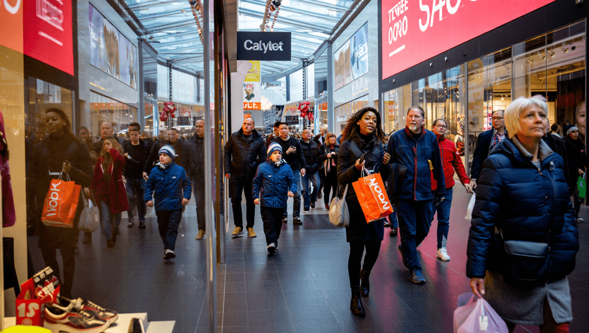 A mobile phone with a bunch of push notifications like "Shop our Black Friday sale!" and "Cyber Monday sale extended!"