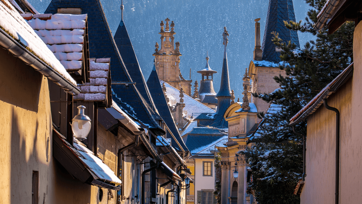 A Man Holding Up A Pretzel At The Christmas Market In Brixen, Bressanone, Italy