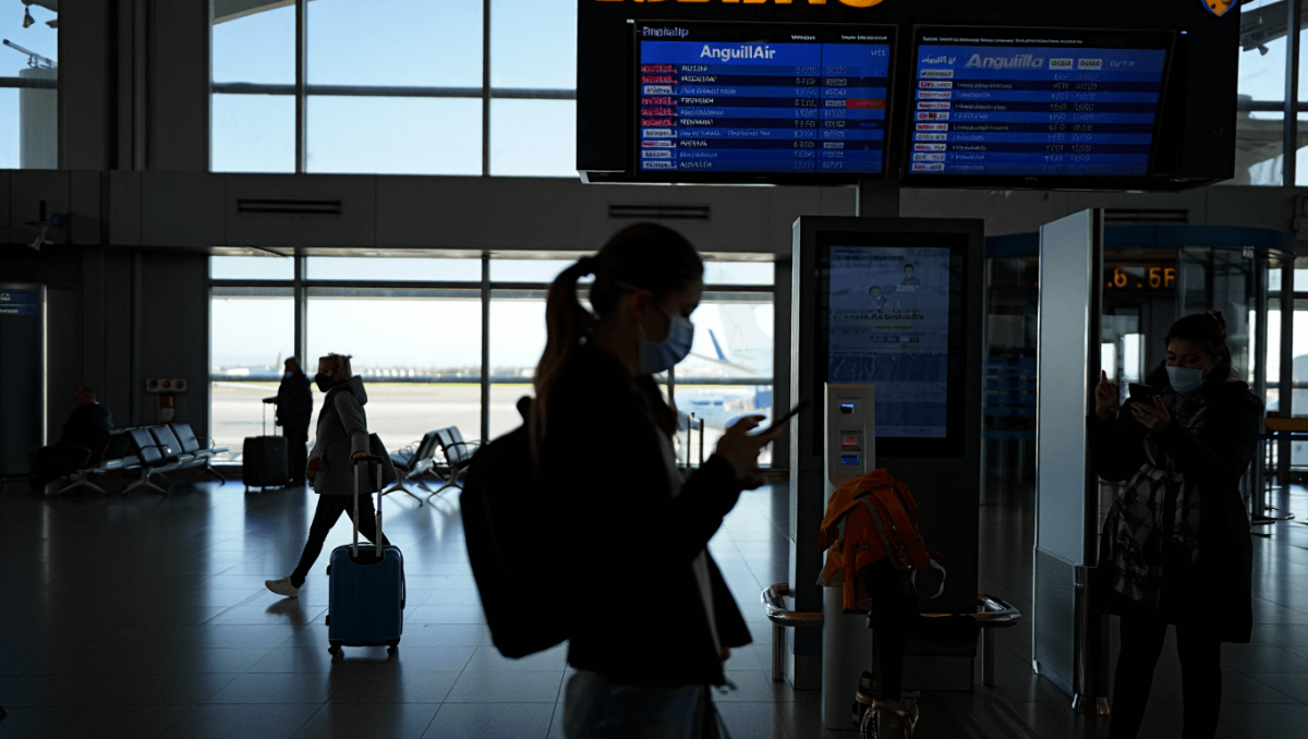 Lone beachgoer walking along shoreline in Anguilla