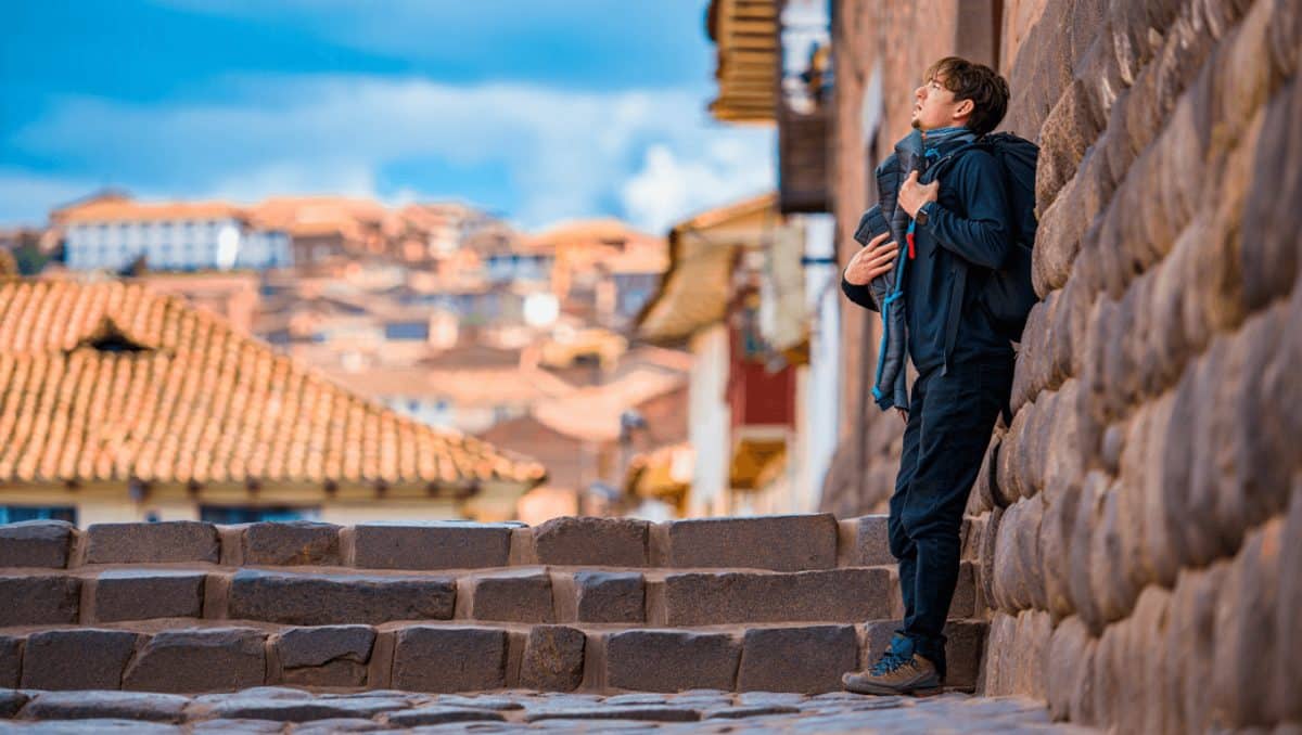 Plaza Mayor and Cusco cathedral in the Old town of Cusco city, and the Andes mountains, Peru. Plaza Mayor or Plaza de Armas is the main square of Cuzco, famous for historical colonial architecture.