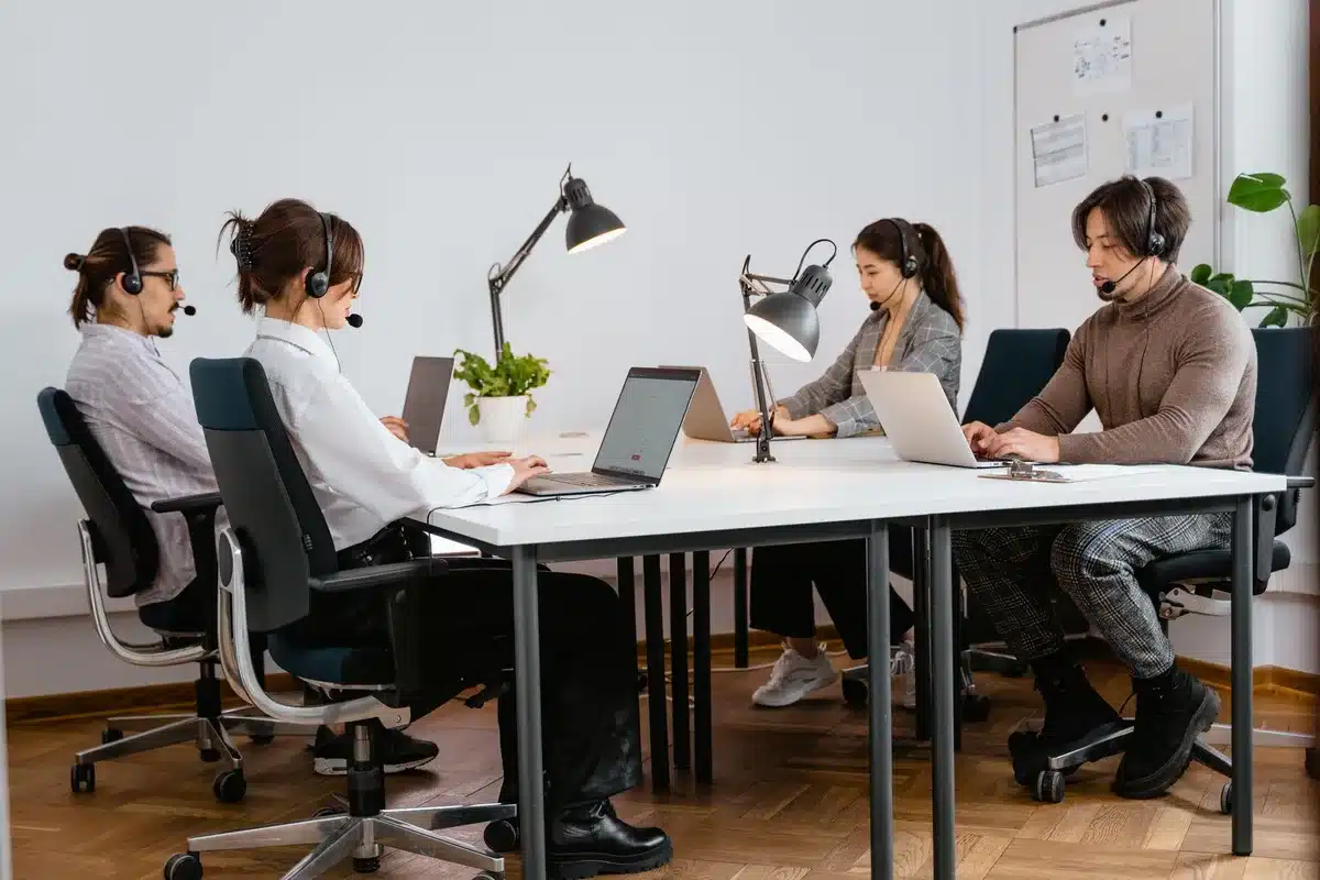 Tech team members working on complex integration workflows and system configurations at desks