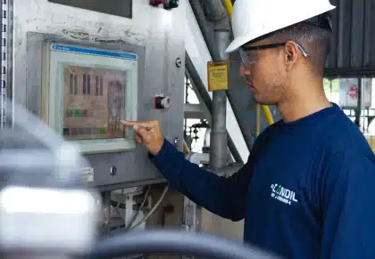 Tech team monitoring integration platform dashboards with real-time data flows and system alerts on multiple screens