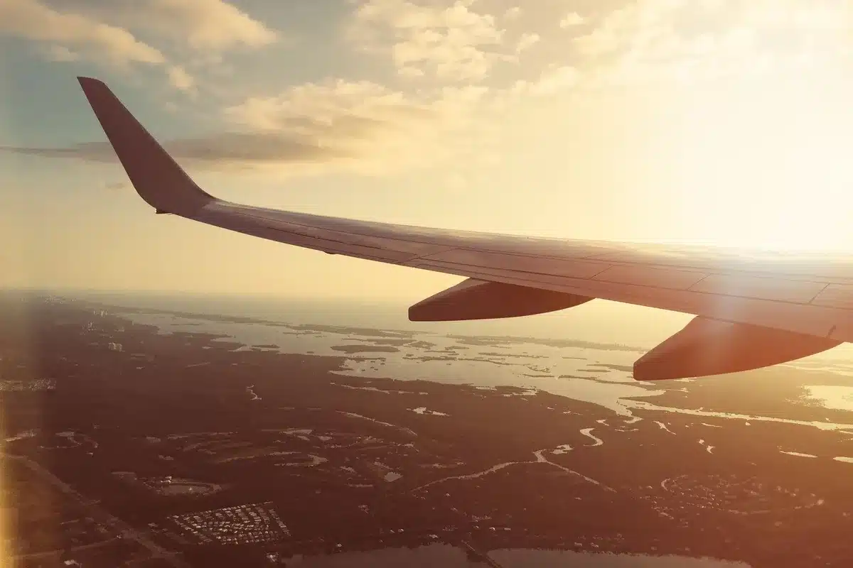 Aircraft window view of Atlantic Ocean with distant European coastline during transatlantic flight