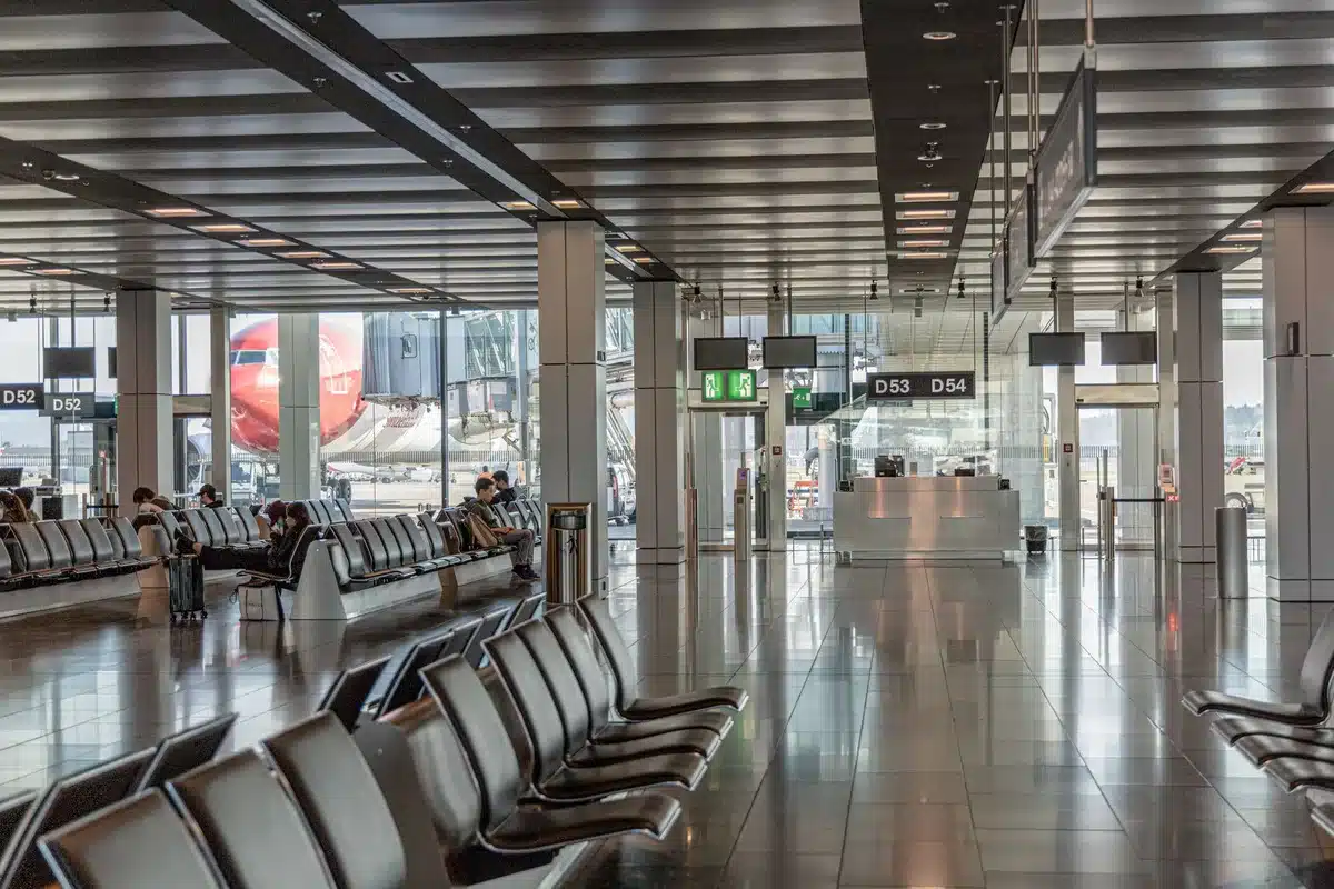 Airport lounge interior with comfortable seating, food service area, and modern amenities