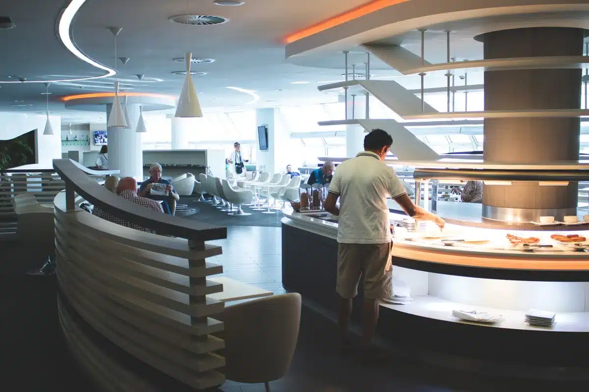 Traveler enjoying food and beverage service in an airport lounge