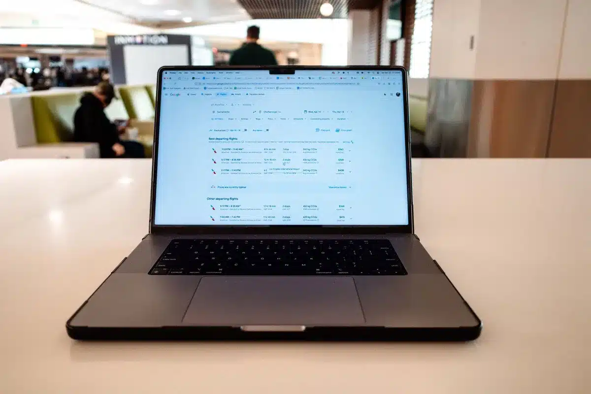 Person booking flight on laptop computer