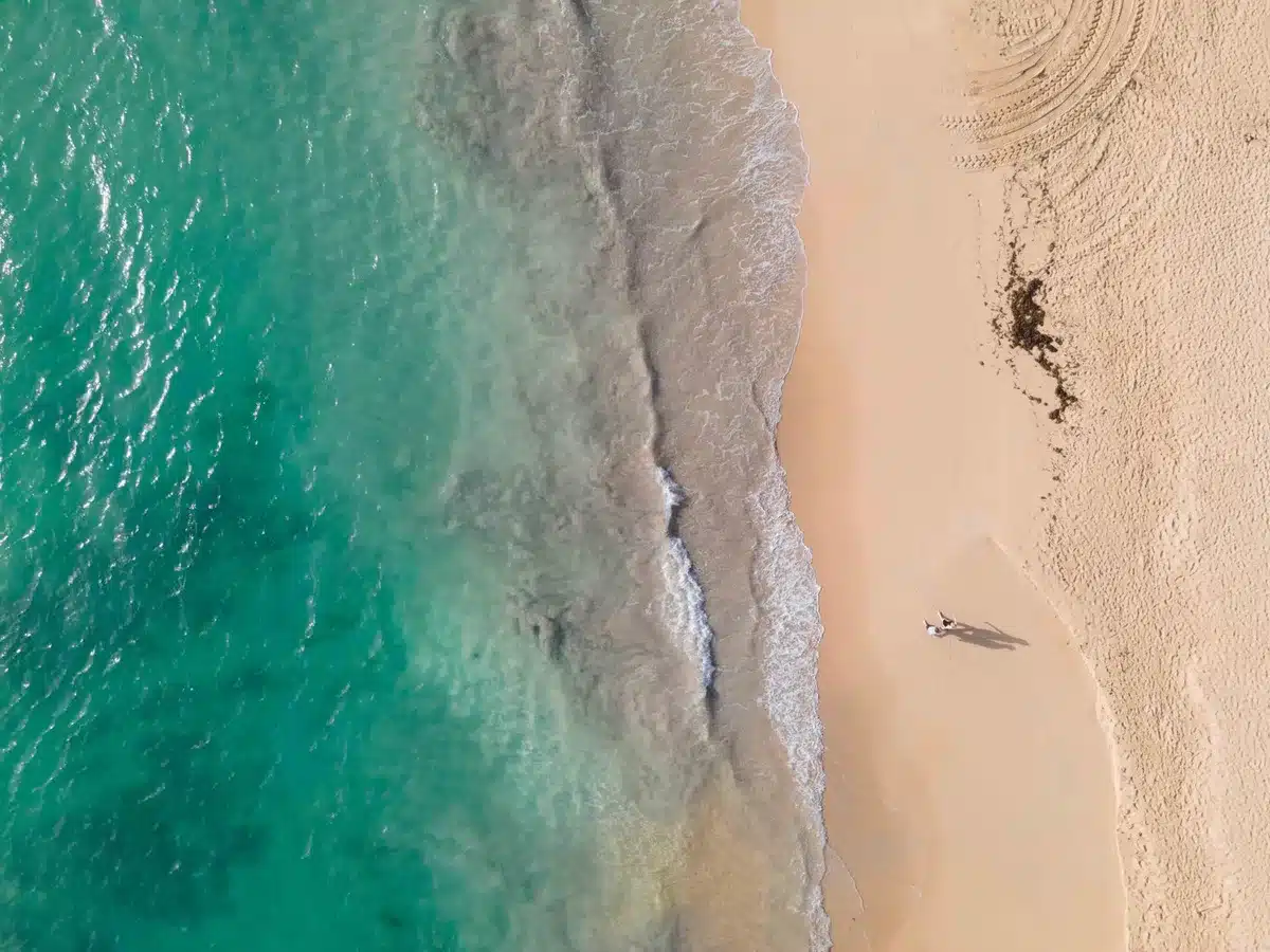 Pristine Caribbean beach with white sand, clear turquoise water, and no crowds