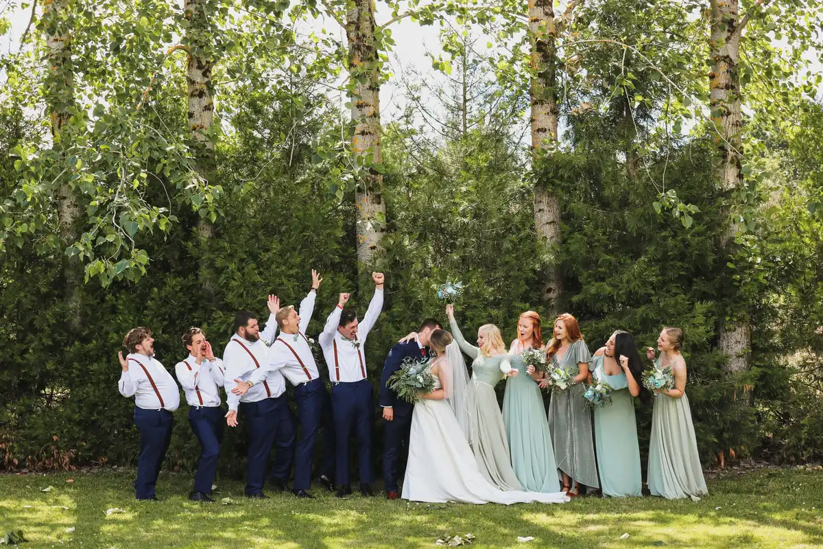 Bridesmaids in strapless seafoam green gowns standing together at wedding ceremony