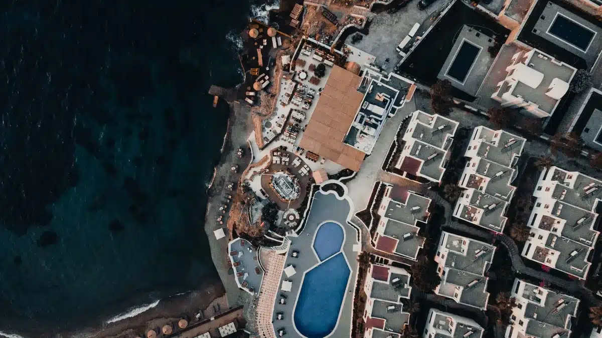 Rooftop infinity pool and bar overlooking ocean at a luxury resort