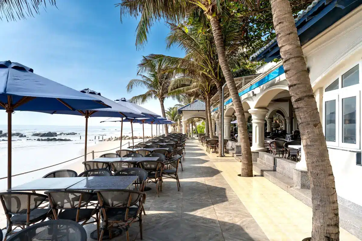 Modern beachfront restaurant with ocean views and elegant table settings