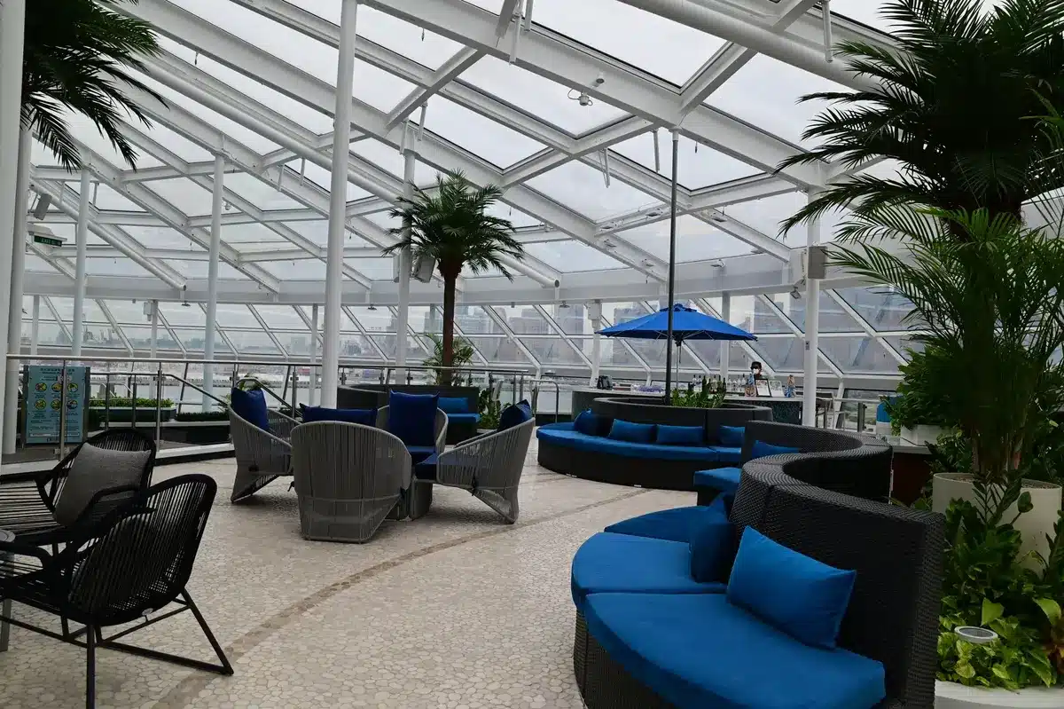 Modern lounge interior with comfortable seating, charging stations, and refreshment bar
