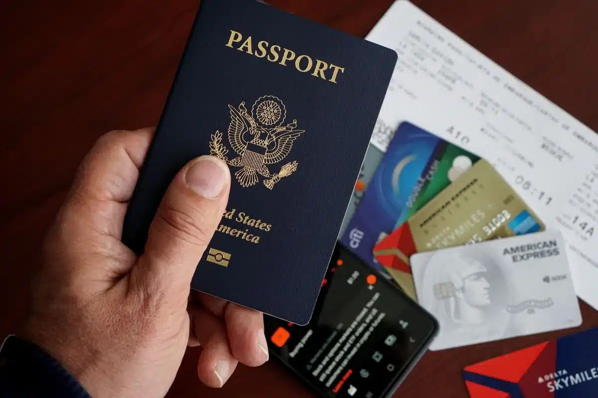 Organized travel items: credit card, ID, event ticket, and mobile phone on a table