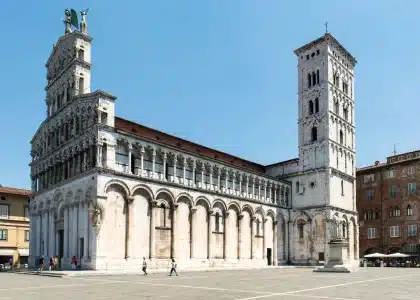 Tranquil Italian Renaissance square with classical architecture and a lone visitor at an outdoor café
