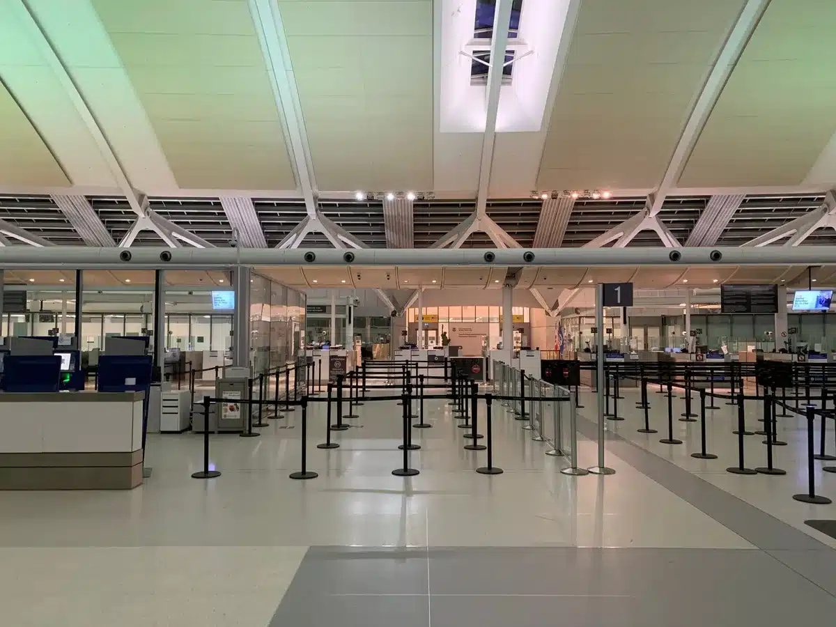 Modern airport terminal concourse with spacious security checkpoint and contemporary gate design