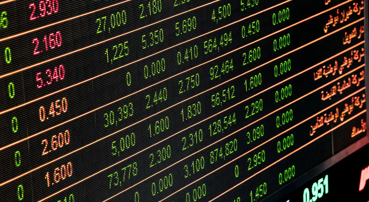 Stock market trading floor with screens showing airline stock data and market activity.
