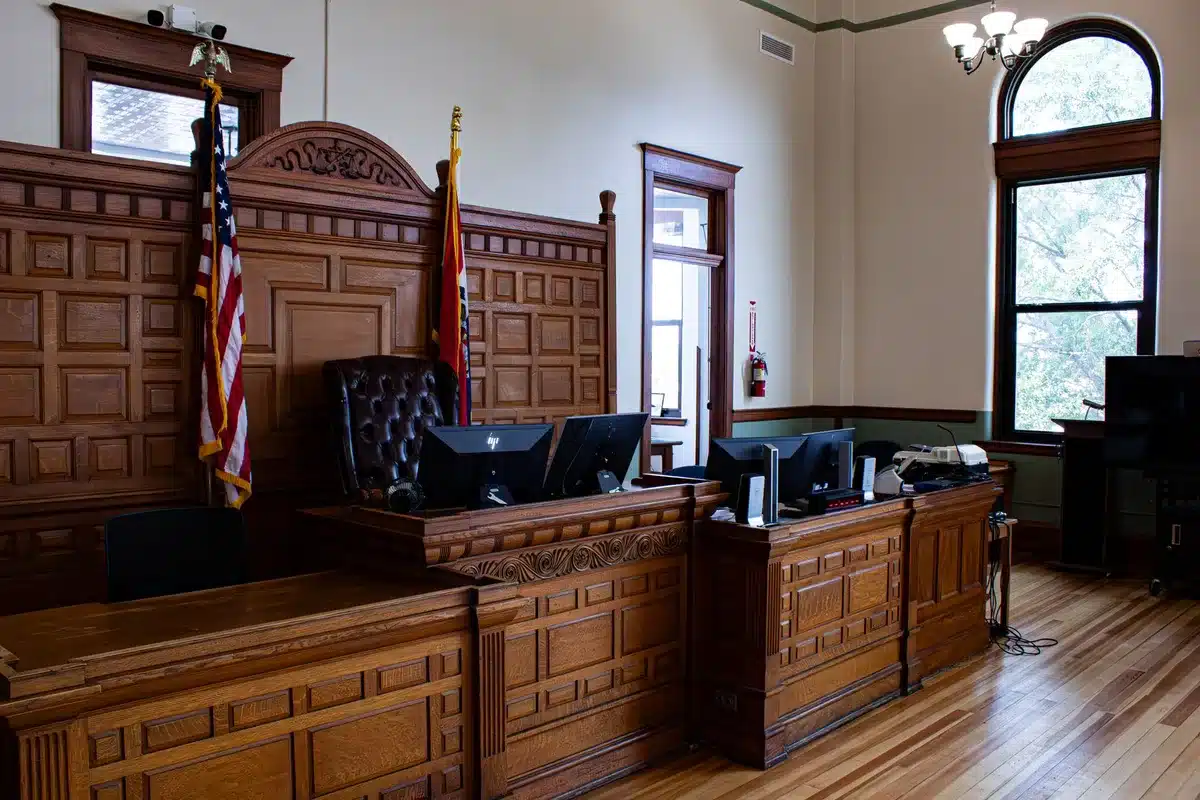 Courthouse hallway with legal documents and airline route maps on desk, representing the court ruling on the Delta-Aerom