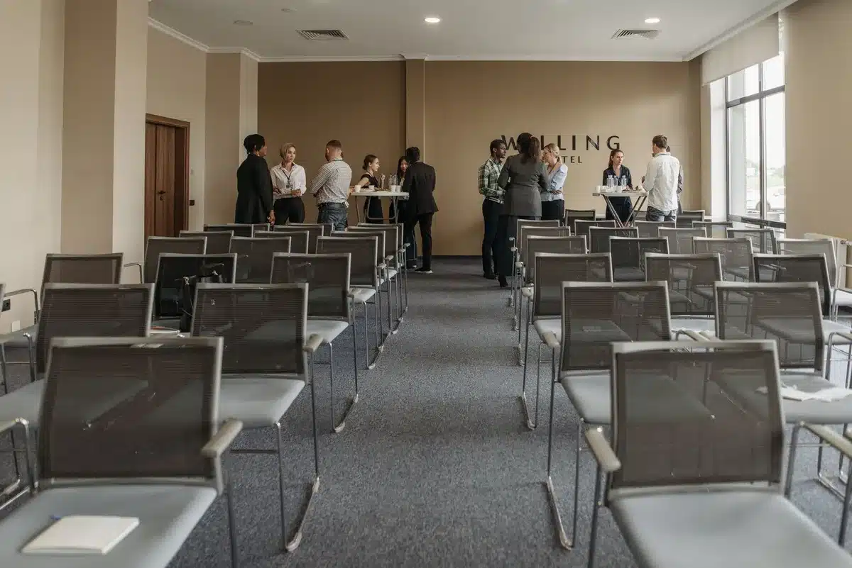 Professional business meeting in a modern hotel conference room with attendees around a table