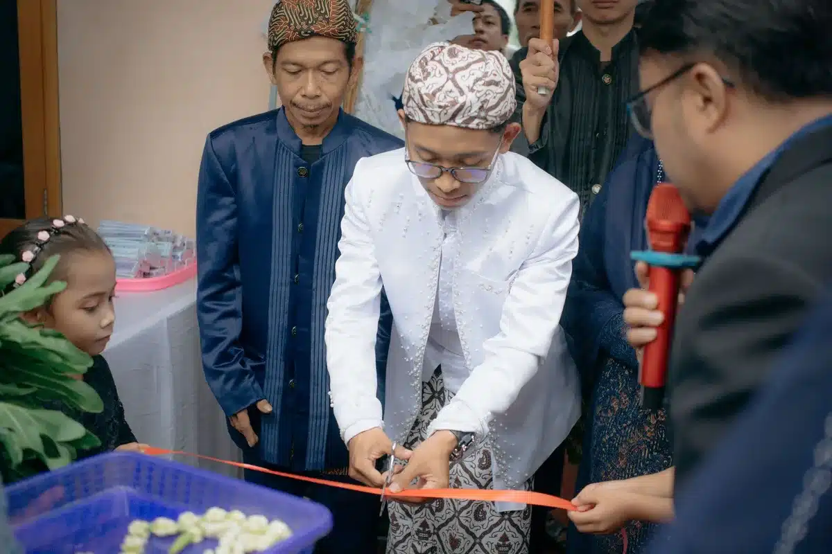 Ribbon-cutting ceremony at a grand opening event with attendees and officials