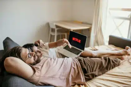 A person relaxing at home watching Netflix on a television screen in a comfortable living room setting