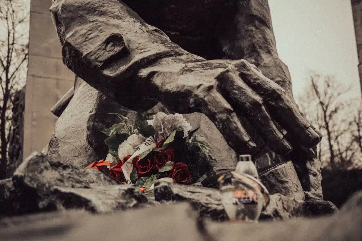 Flowers and tributes left at a memorial statue