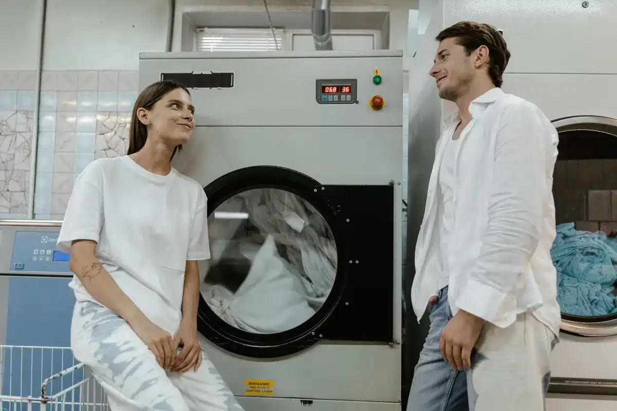 A vintage scene of two people meeting in a laundromat, evoking the 1960s era