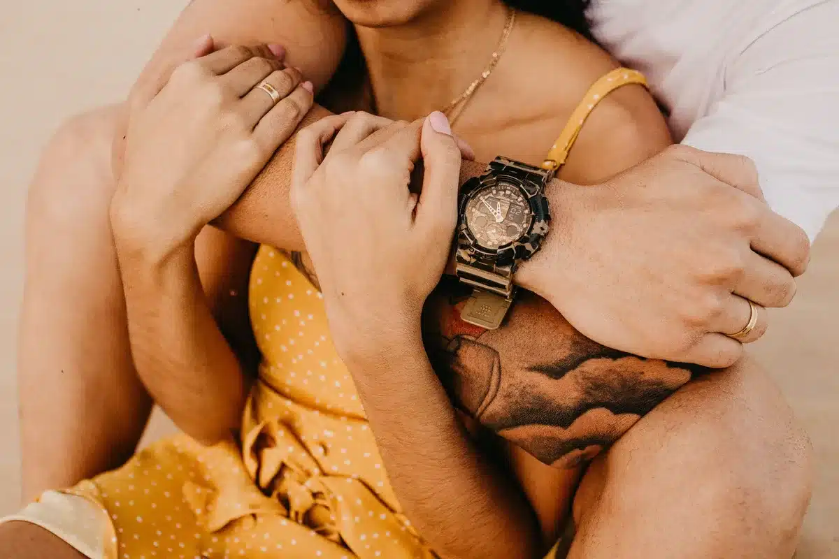 Two people holding hands in a tender moment, symbolizing enduring love and partnership