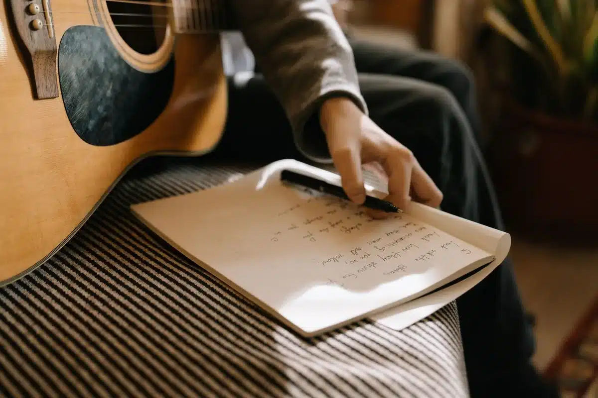 Songwriter with guitar composing music in a creative moment