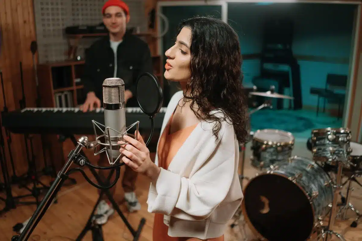 Recording artist performing in a professional studio with microphone