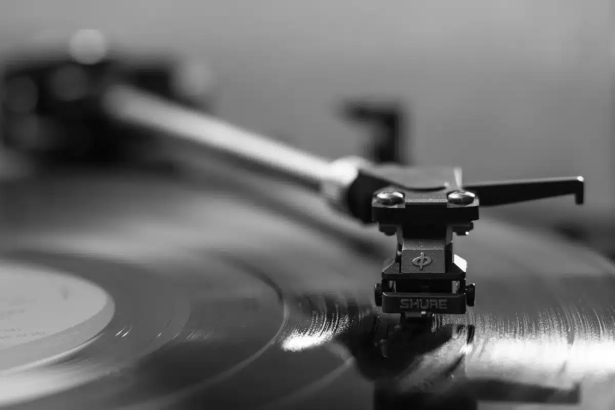 Vinyl record spinning on turntable with musical notes