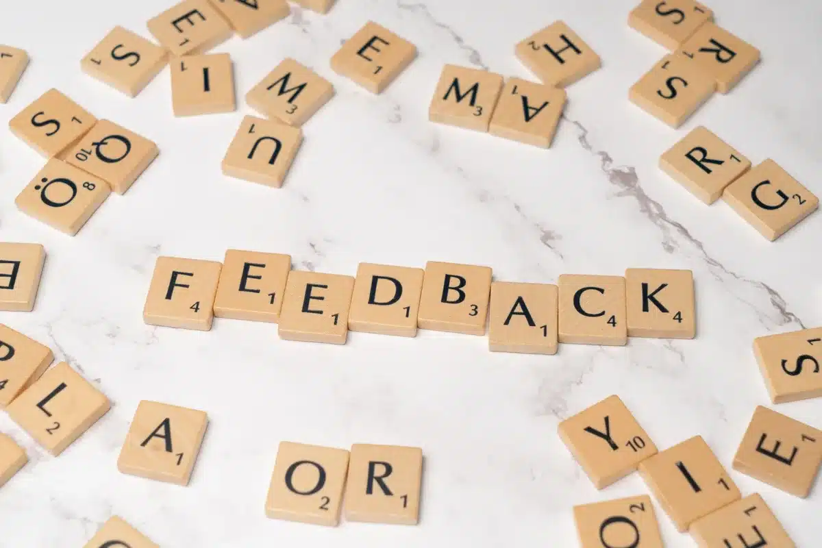 Person reading customer feedback on a screen or reviewing survey responses