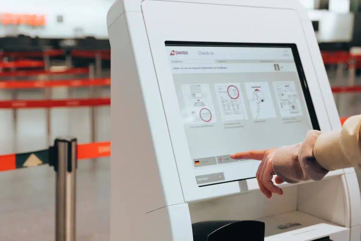 Passenger using mobile check-in technology at an airport kiosk