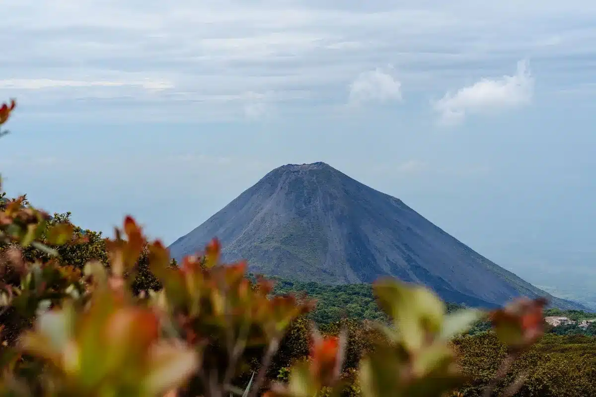 Volcán de Agua dominates the skyline above lush green valleys and colonial architecture in El Salvador