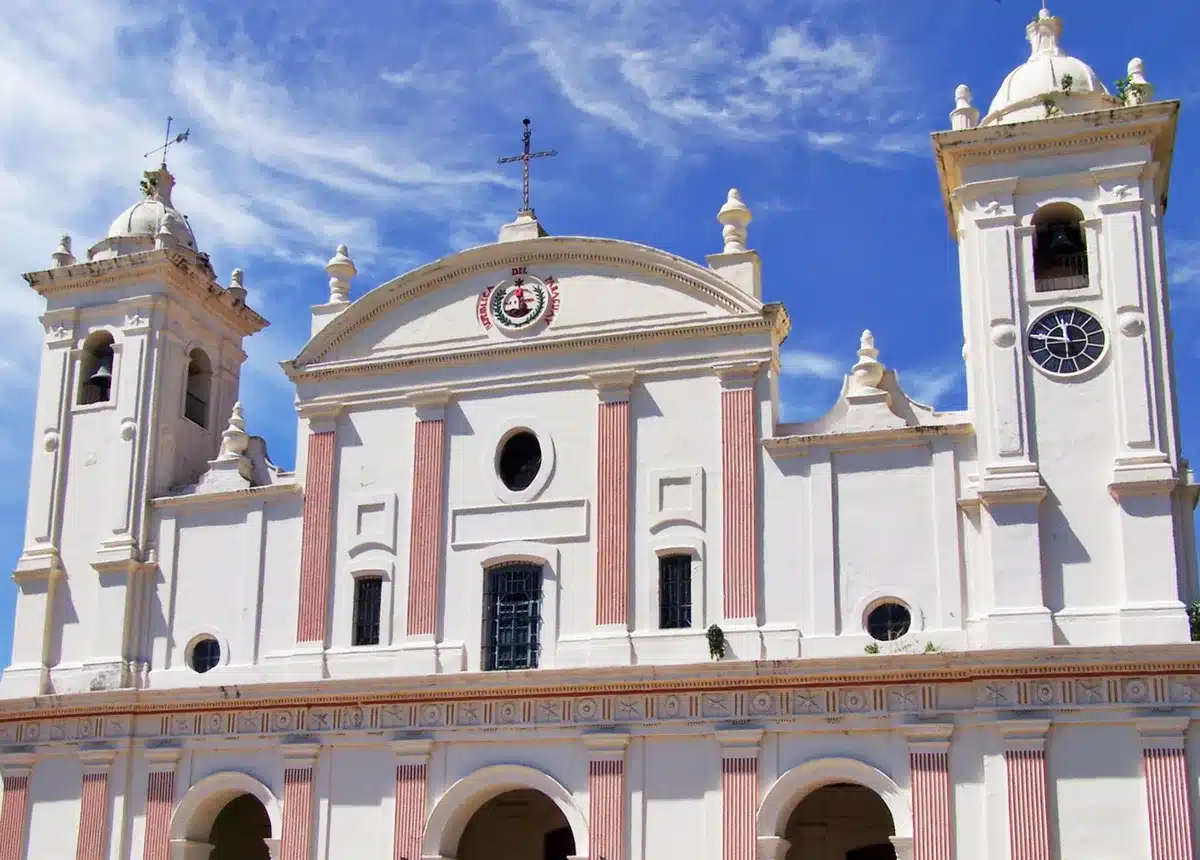 Colonial buildings with pastel facades line a peaceful plaza in Asunción, Paraguay's capital city