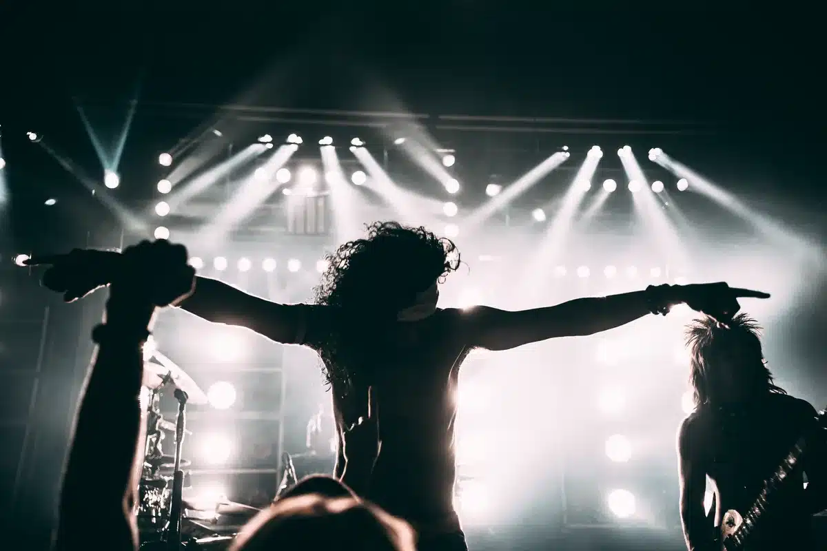 Band members performing together onstage, honoring a departed bandmate