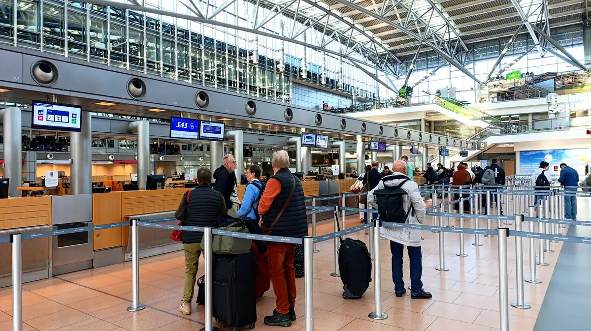 Business traveler in priority boarding queue at airport gate