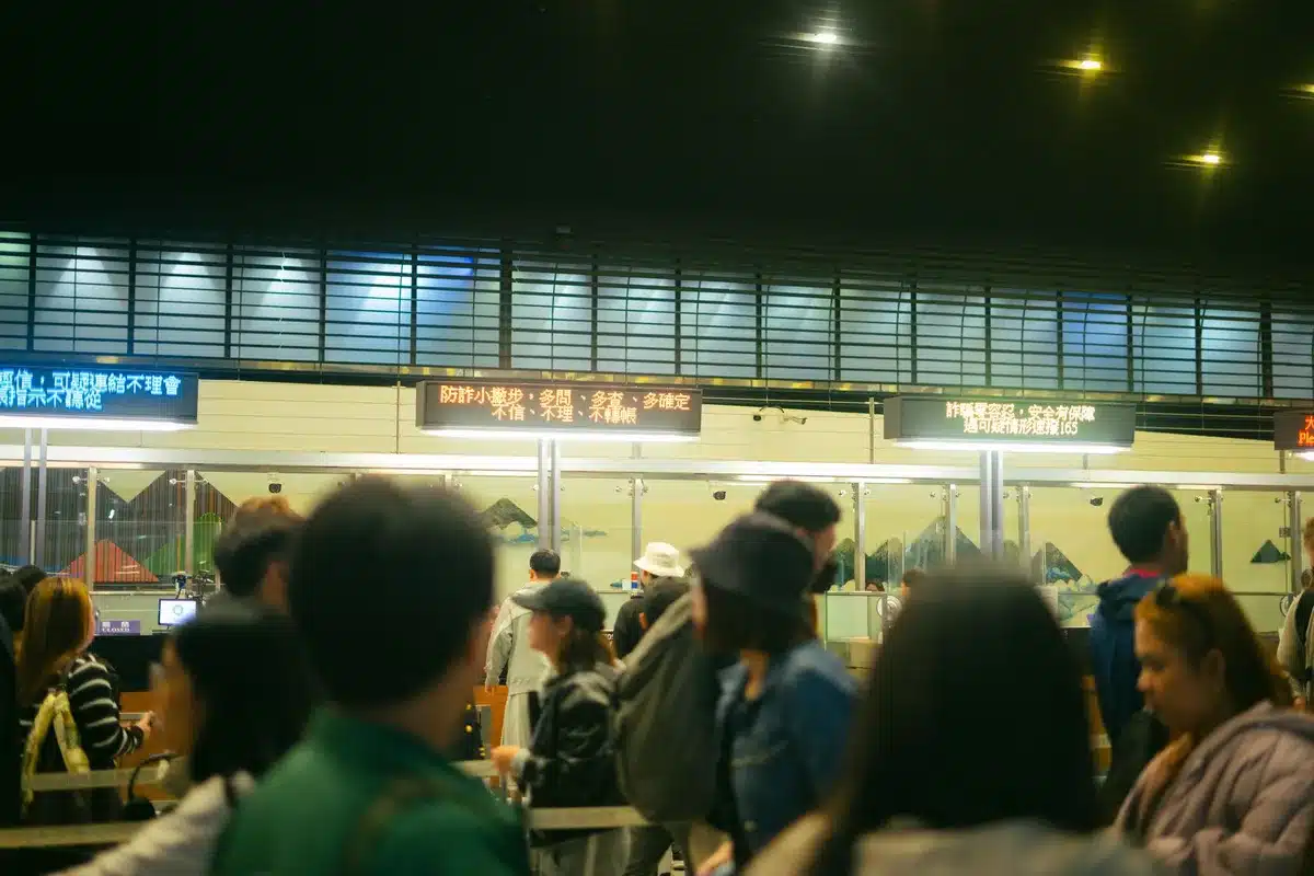 Customers waiting in line outside a modern frozen yogurt shop with bright signage