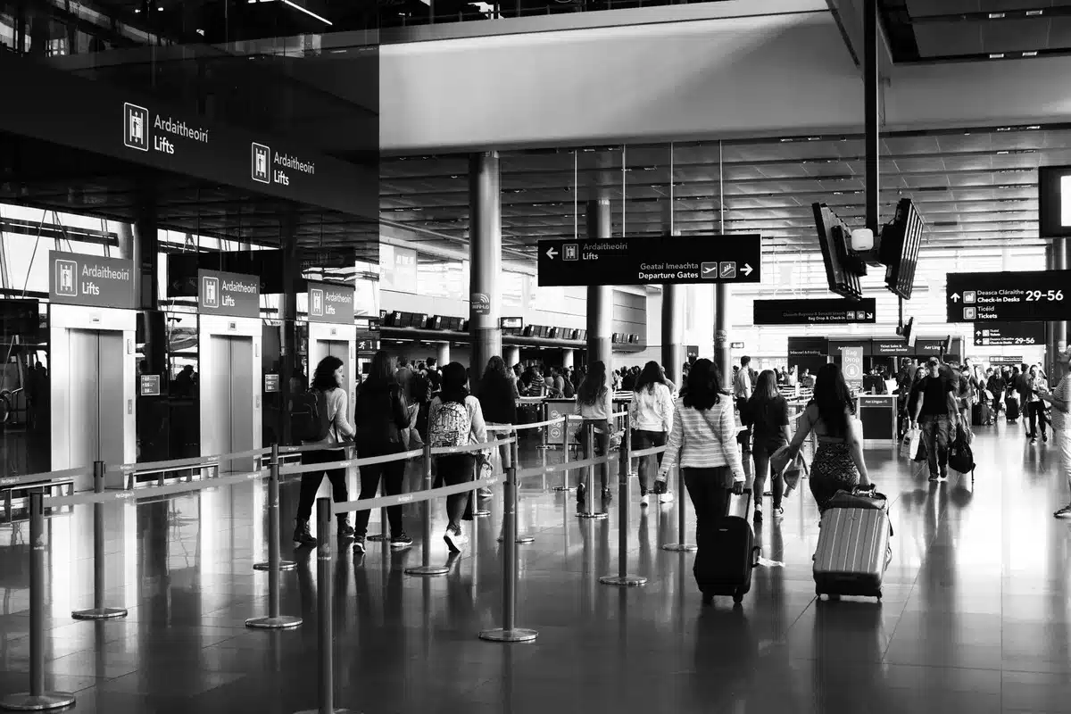 Woman with luggage walking through an airport terminal