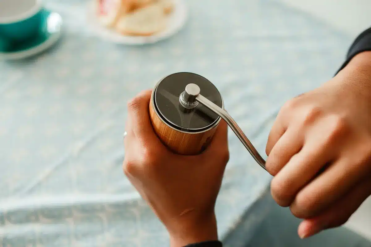 Hands preparing coffee in a quiet domestic moment, showing ritual and routine.