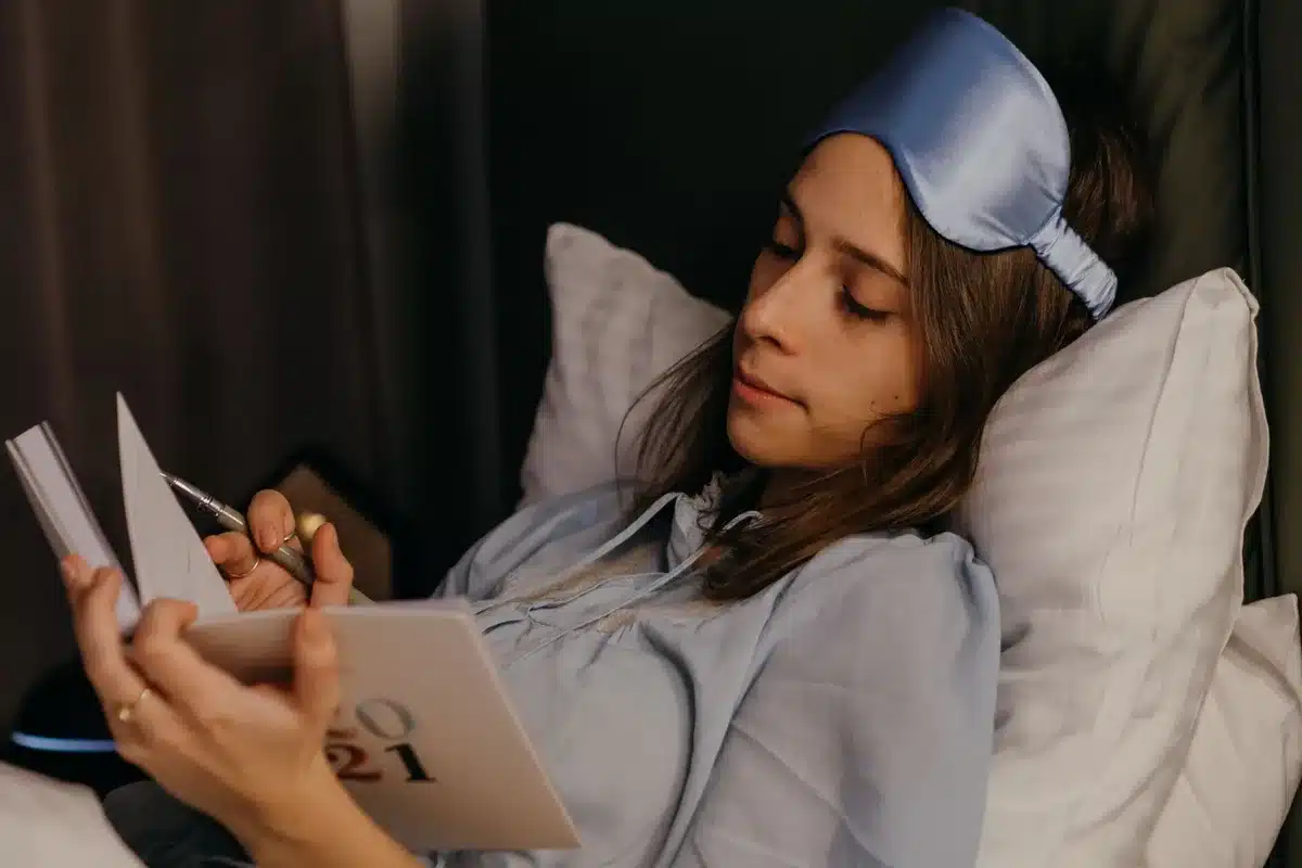 Woman taking time for herself, journaling or reflecting in a peaceful personal space.
