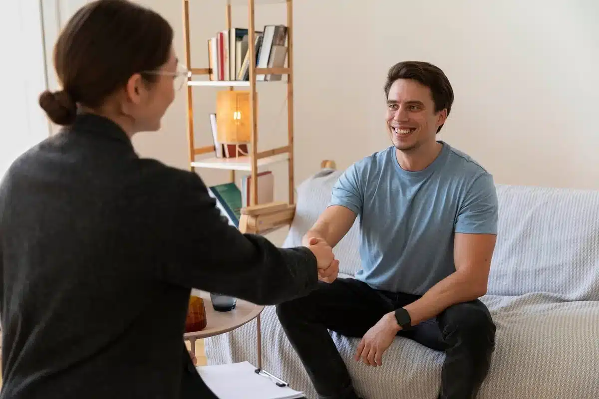 Counselor and client in a supportive therapy session, representing post-release supervision and mental health programs