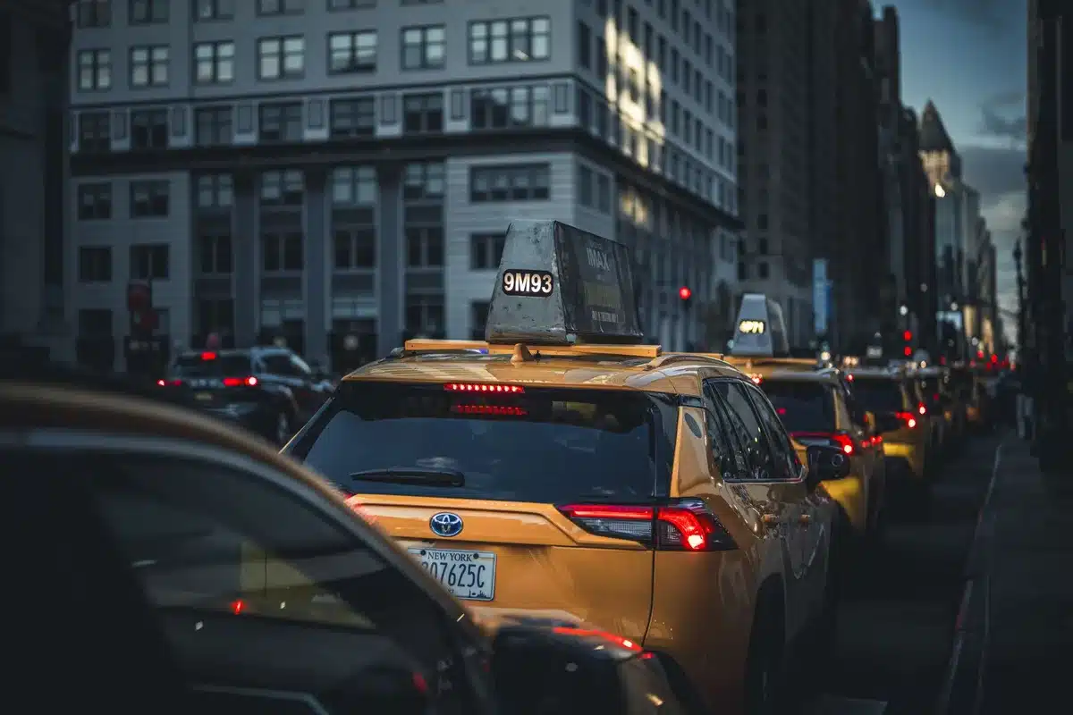 Yellow taxi on congested New York City street with heavy traffic