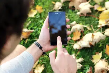 Hand interacting with smartphone showing personalization settings on Google app interface