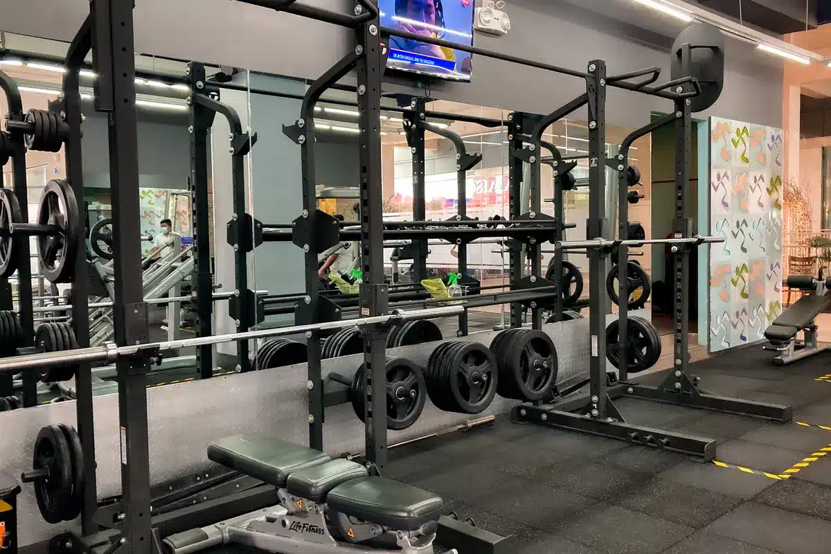 Interior of a modern fitness gym facility with equipment and corridor