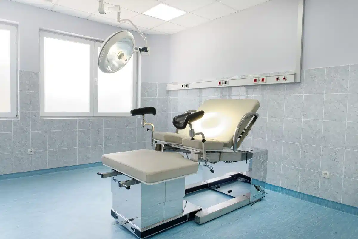 Hospital examination room with medical equipment and documentation