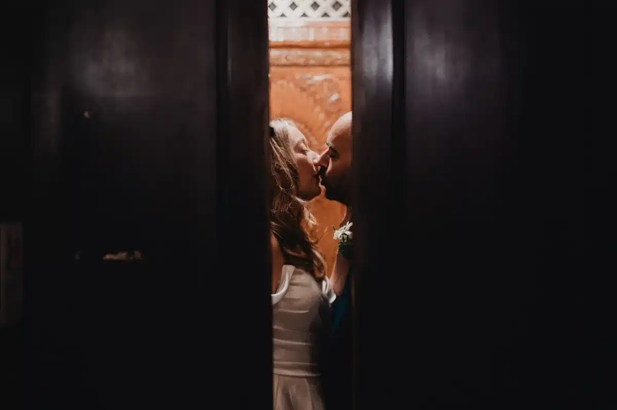 An intimate wedding celebration at a restaurant with close friends and family gathered around a couple.