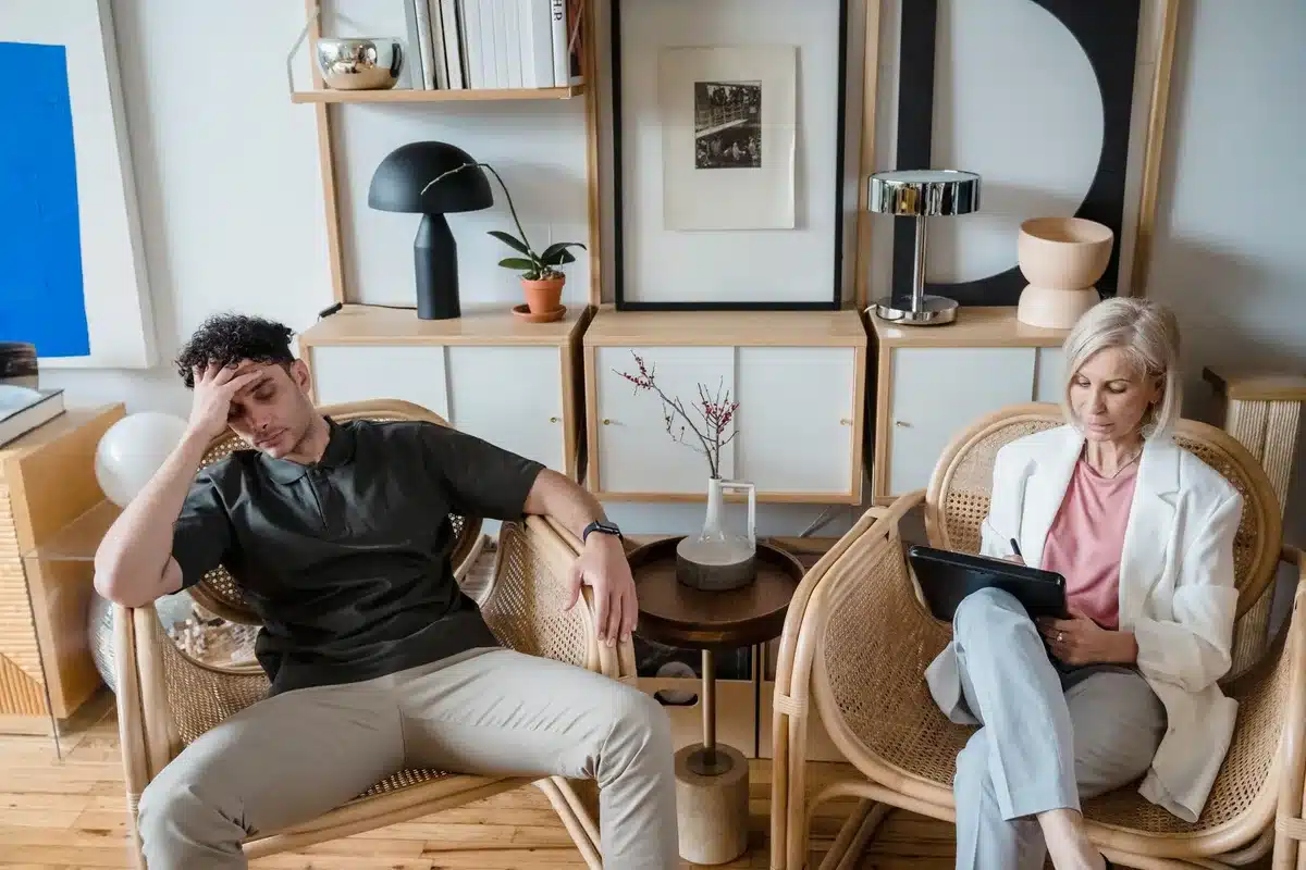 Two people in conversation in a calm indoor setting, representing professional analysis of emotional attachment and rela